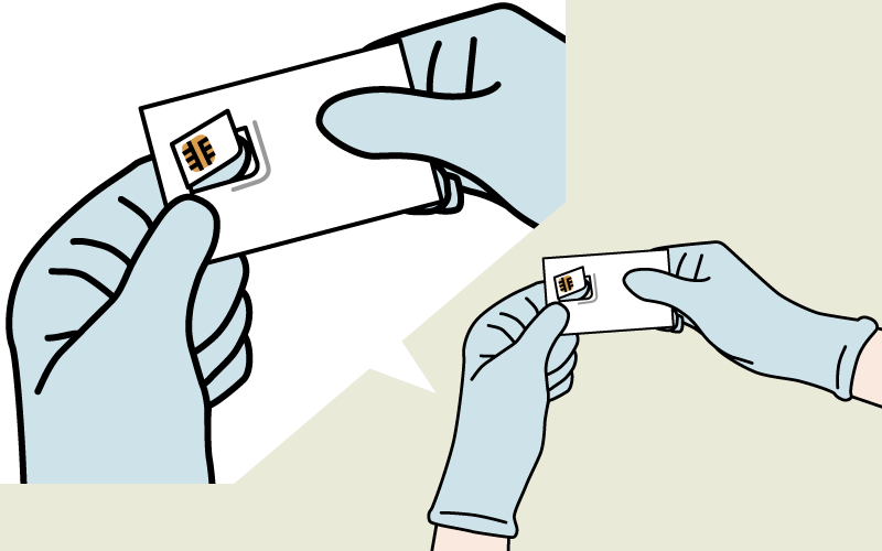 Handling a SIM card with gloved hands.