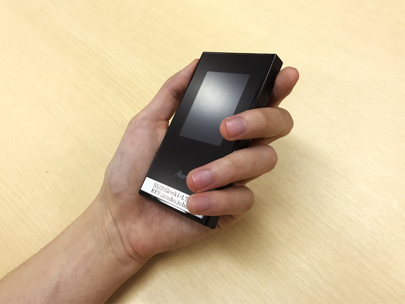 a hand holding the genki mobile pocket wifi