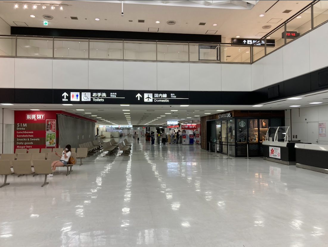 Narita airport terminal 2 on the way to JAL ABC counter with domectic flight sign and restrooms nearby