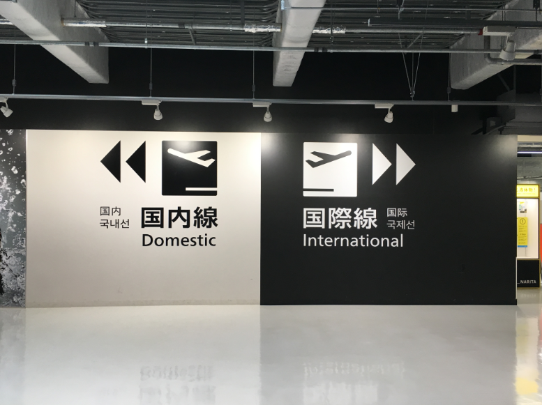 Narita Airport Terminal 3 wall signs for domestic and international directions.